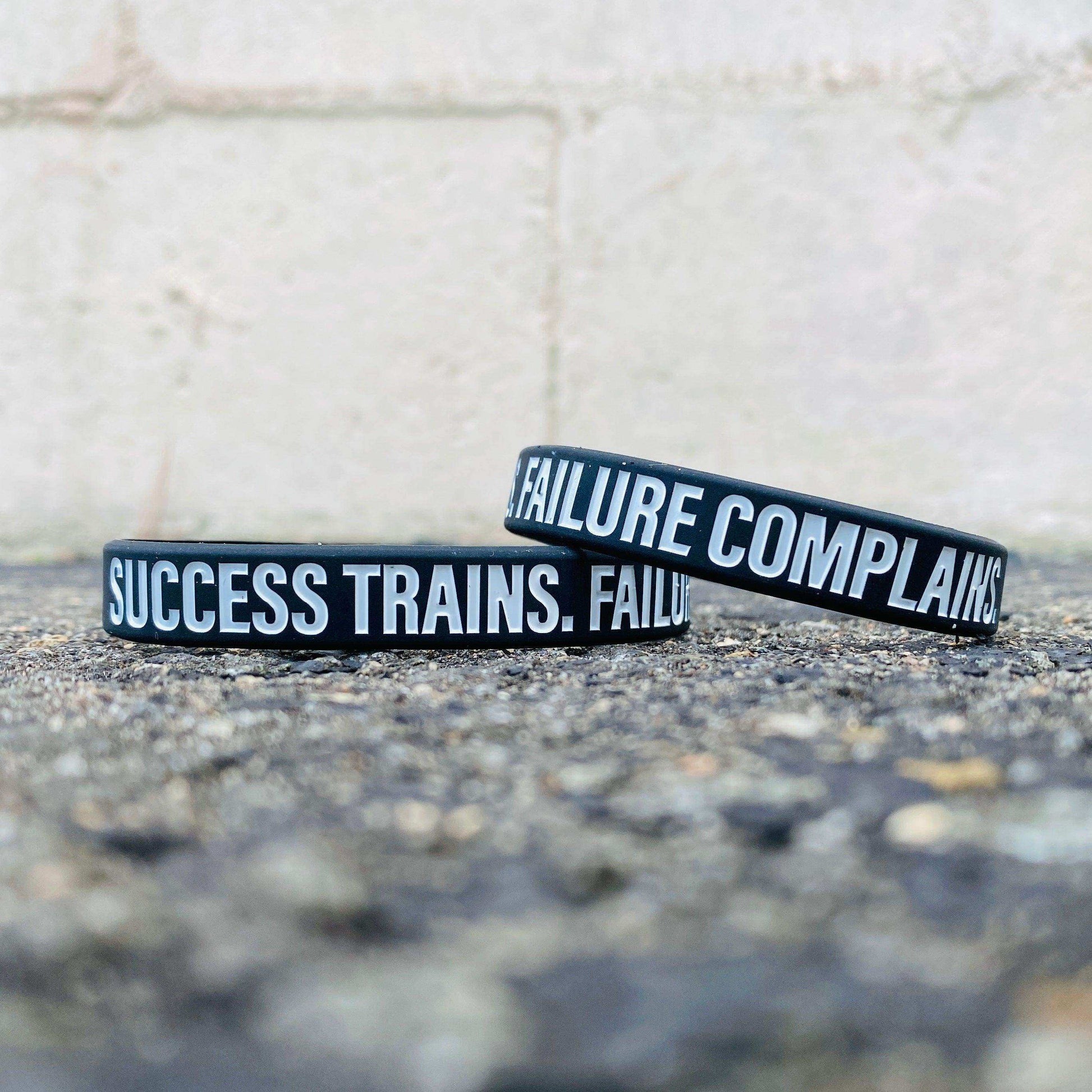 SUCCESS TRAINS. FAILURE COMPLAINS. Wristband - Skoutley Outdoors LLC